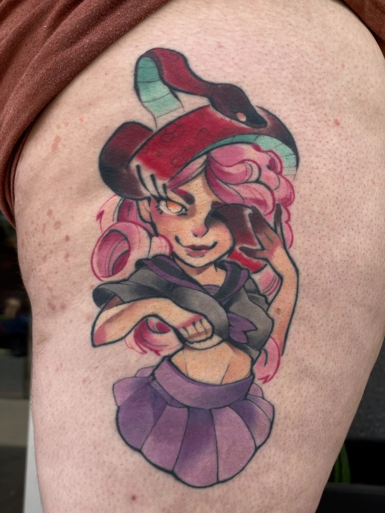 A healed tattoo depicting a femme character with a snake emerging from their left eye.