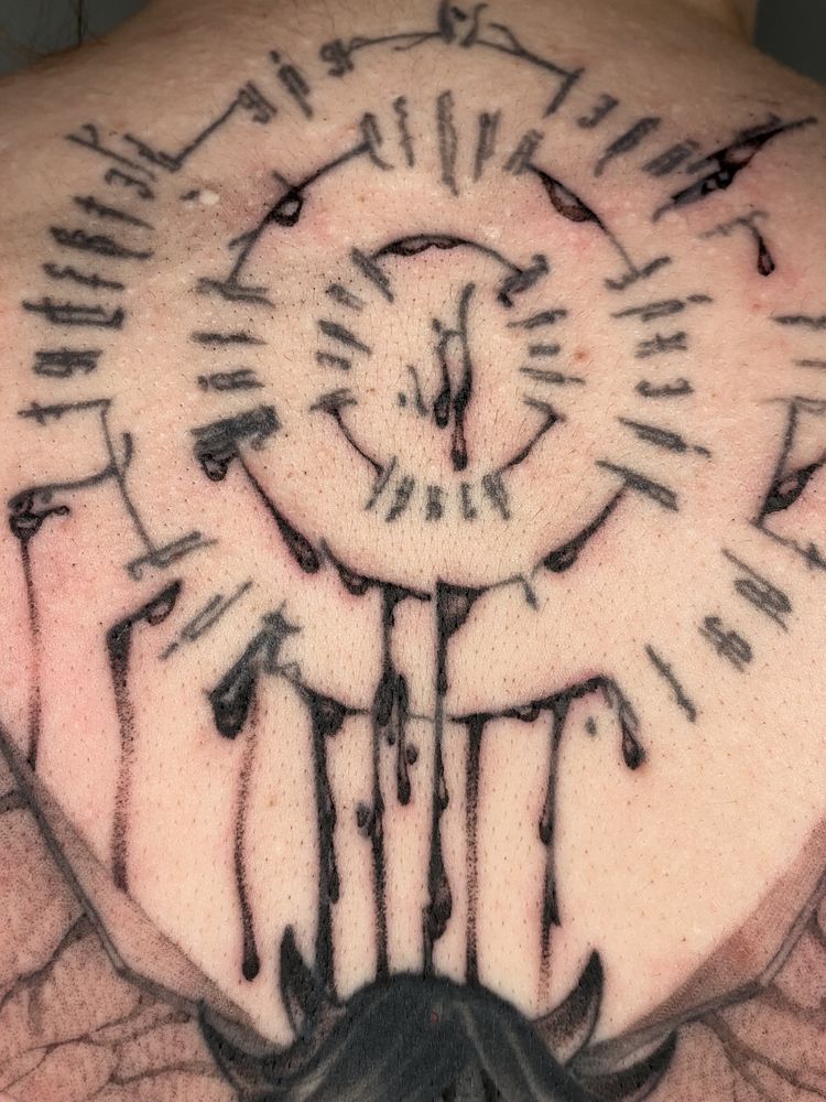 A tattoo depicting the infernal language from ‘Dungeons and Dragons.’ This specific infernal is on the back of the character Astarion from the game ‘Baldur’s Gate 3’