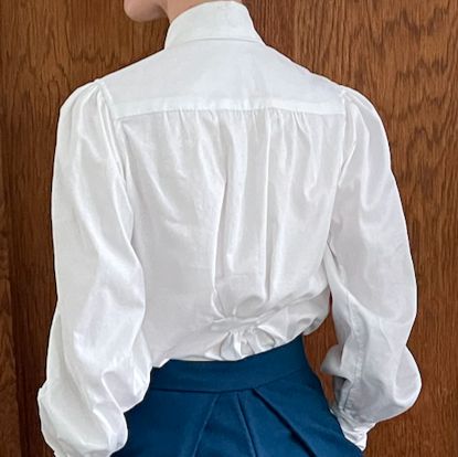 The back of the white shirt. 