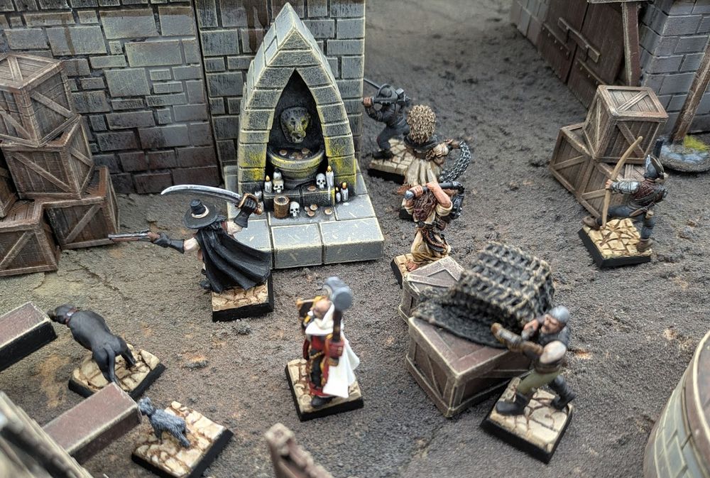Witch hunters patrol the streets of a fantasy city in a game of Mordheim. 