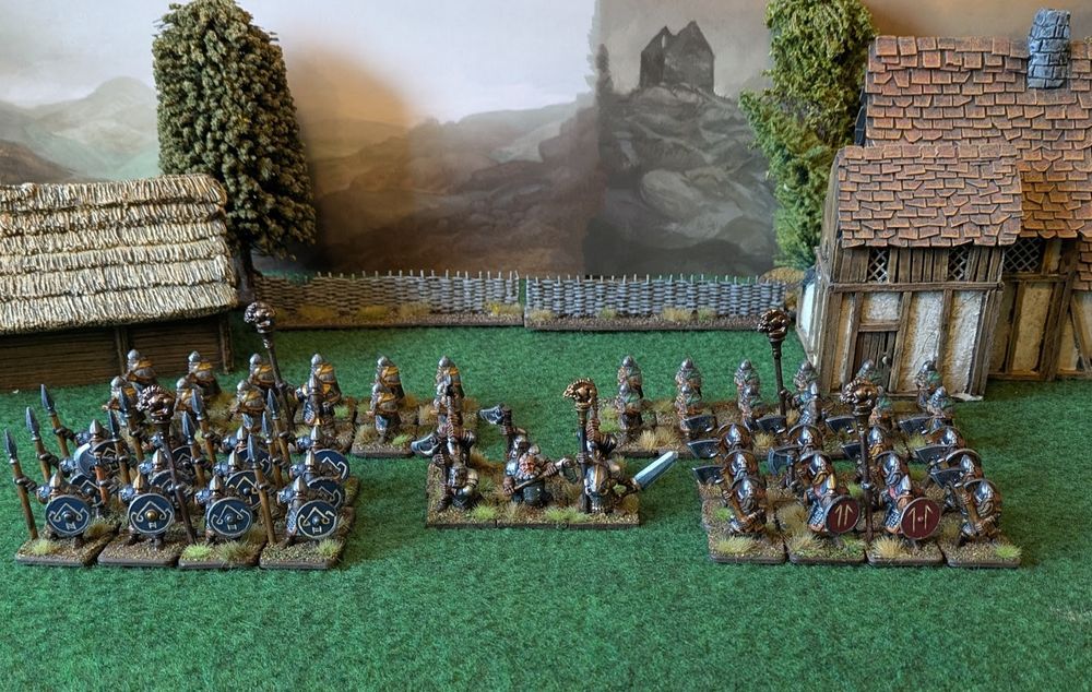 A photograph of an army of miniature figures: ranks of armoured dwarves, most of whom are old monopose plastic models from the 1980s.