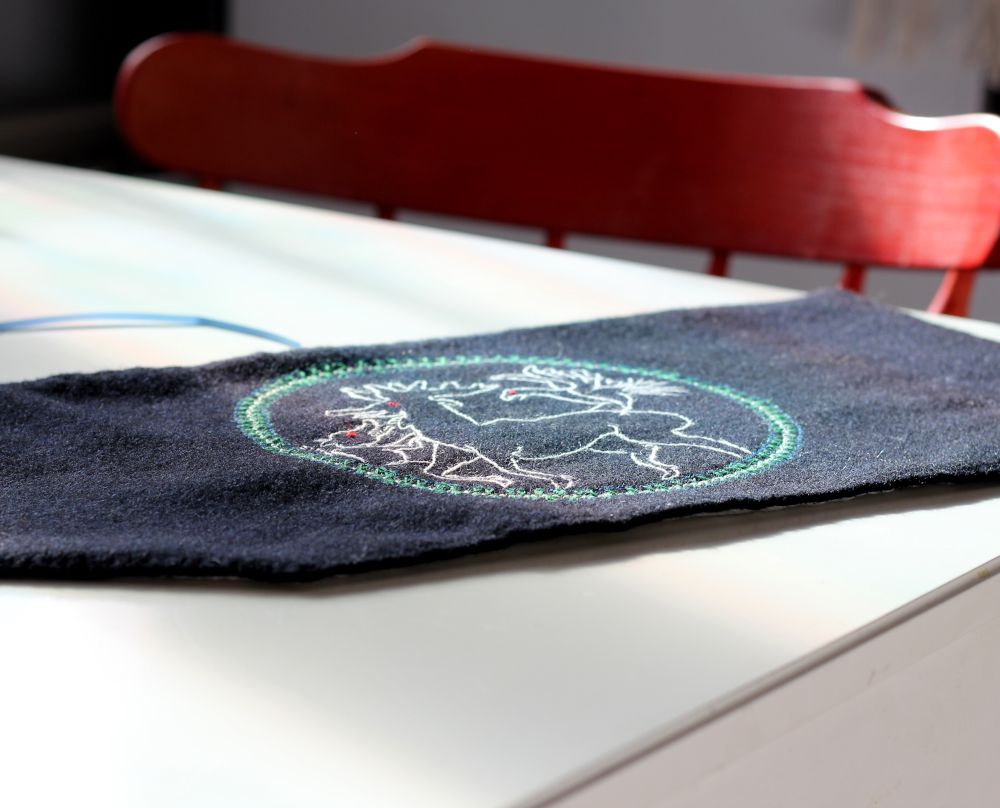 Tool case with embroidery on a white table