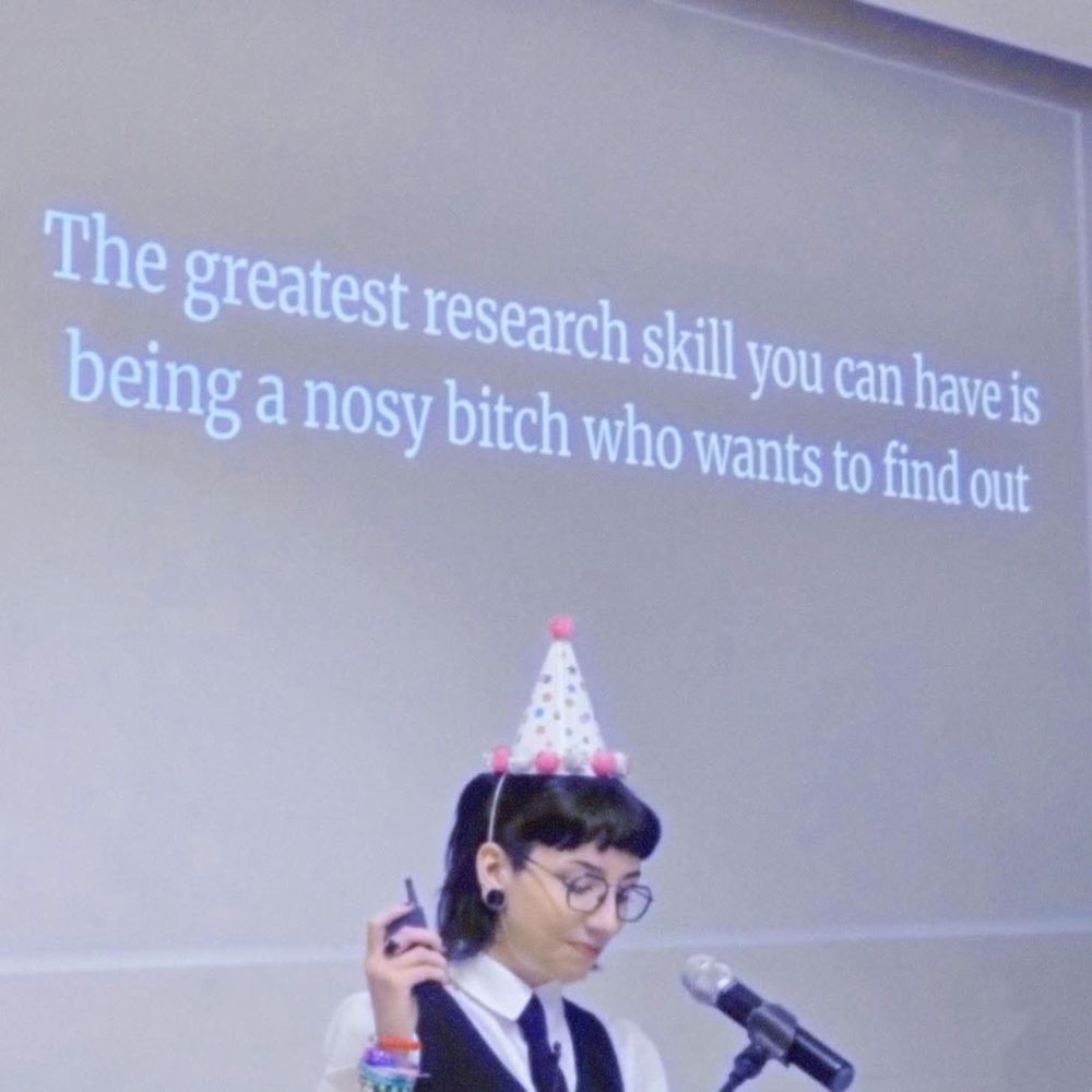 Person in a party hat giving a presentation and it says The greatest research skill you can have is being a nosy bitch who wants to find out