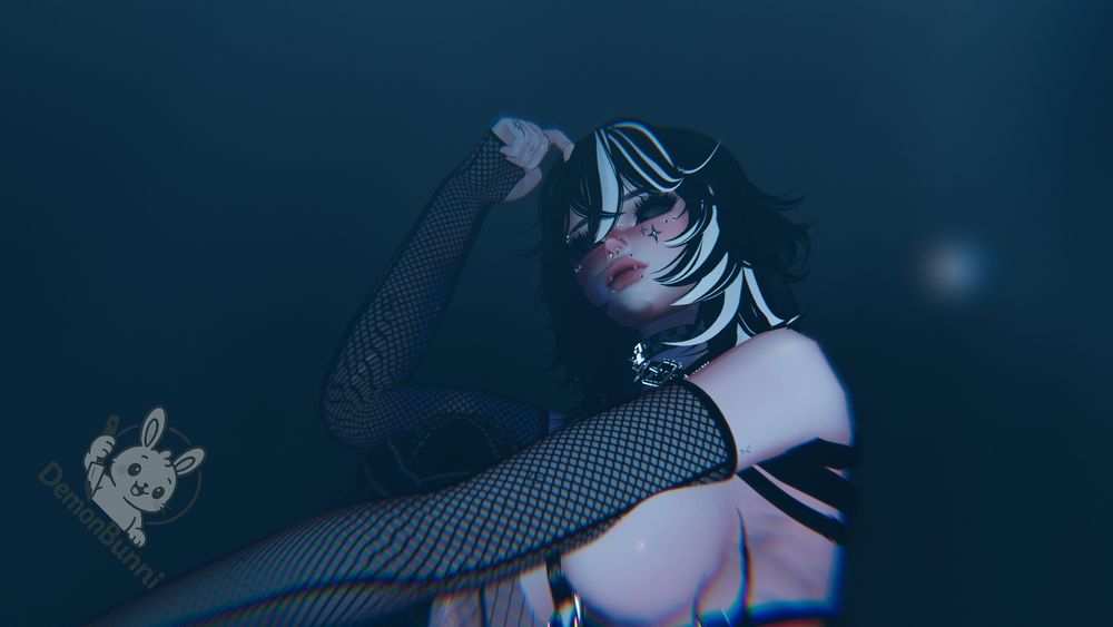 Photograph of a digital avatar with black and white hair, wearing fishnet sleeves, jewelry, and star makeup. The avatar is in a dark blue setting. The logo "DemonBunni" is in the bottom left corner.