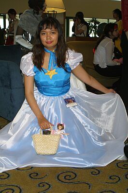Nadeshiko Kinomoto cosplay with a Cardcaptor Sakura doll in a basket