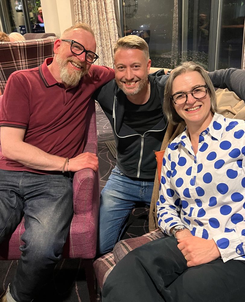 Three happy people posing for a photo 