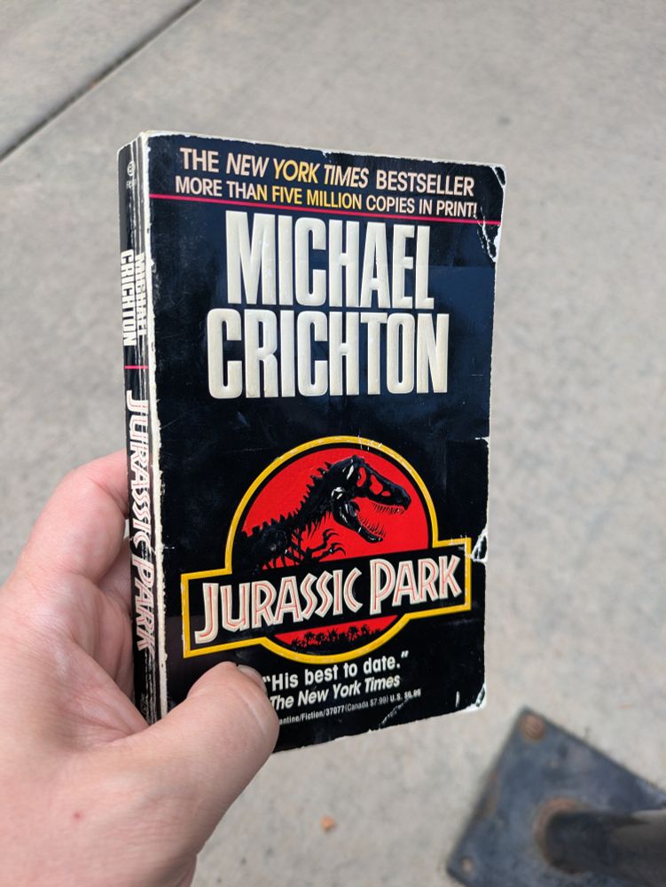 A beat up paperback copy of Jurassic Park.