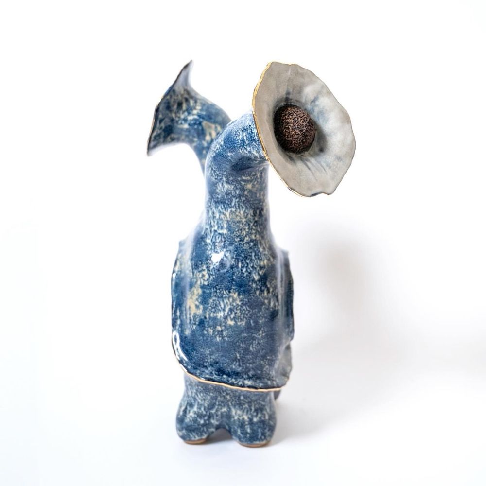 A side view of the same sculpture. It is thinner in depth than it is wide and the hole is no longer visible as it runs parallel to this view.