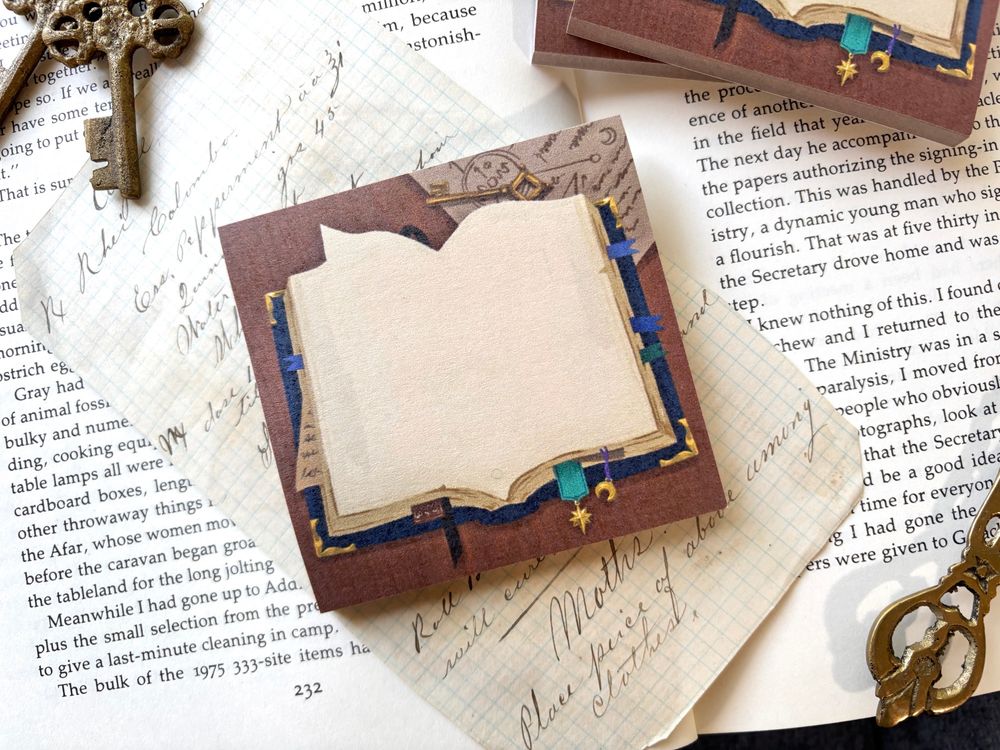 A sticky note with an open wizards book