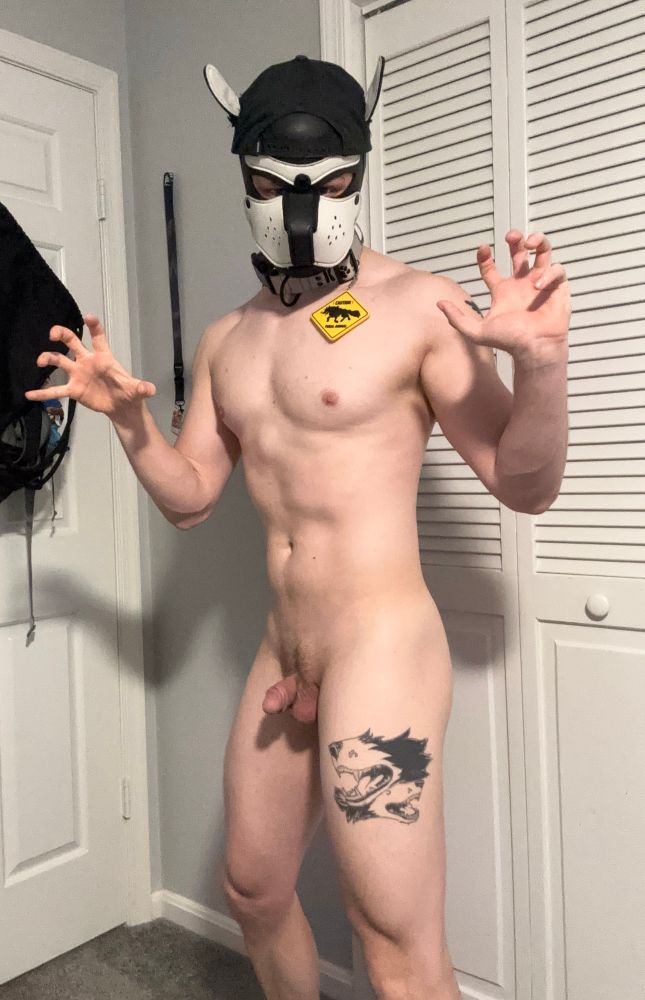 Making claws with my hands while standing in profile with the camera