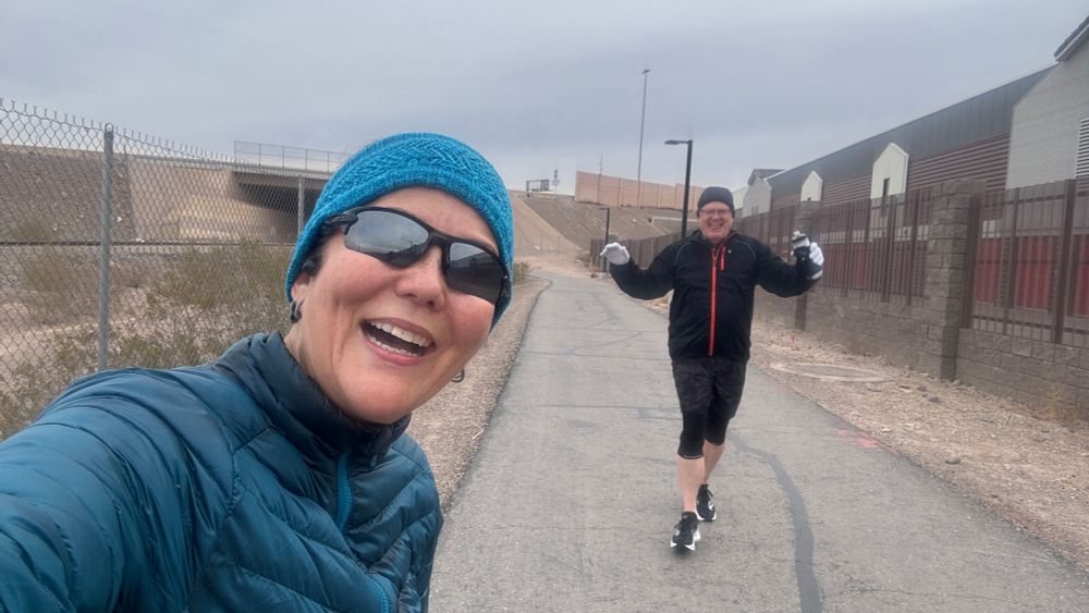 “Selfie” of two happy runners on an asphalt running path. 