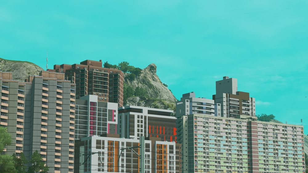 View of the Sedasilap skyline (district of Enulaeyka), mostly slab apartment blocks. In the centre of the background, a mountain with a distinct rock formation can be seen.