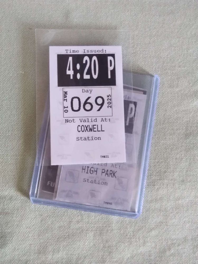 A Toronto Transit Commission (TTC) paper station transfer. The transfer was issued at 4:20 PM on day 69, which is March 10 (Mar 10, Mario) of 2025. The station it was issued from was Coxwell Station. 

Behind the transfer is a toploader meant for protecting cards, and within the toploader is another transfer from a previous year, this transfer being issued from High Park Station.