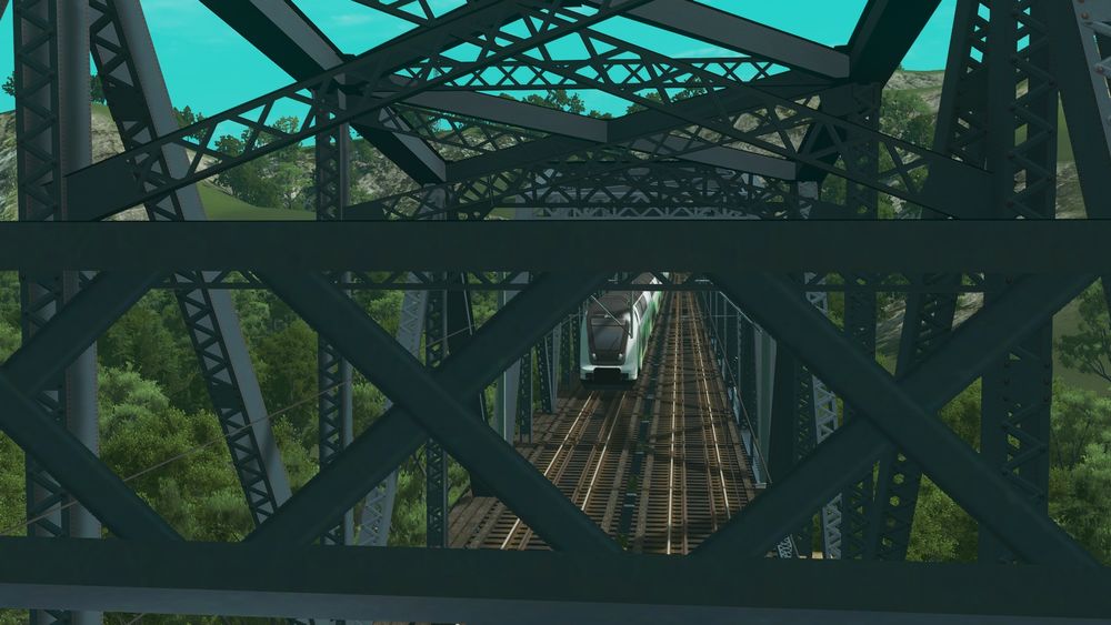 A TWINDEXX cab car seen from the portal bracing of the bridge trusses.