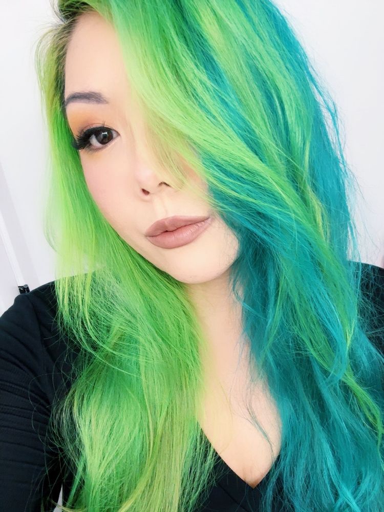 Photo of kimberly with a split dye of neon alien green and teal. Wearing hair in a side part so some of the green is on top of the teal


🧡🖤
👻🖤