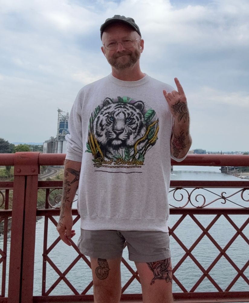 hi from me on the Broadway Bridge in Portland Oregon while wearing a vintage gray white tiger sweatshirt and short shorts with a peek of my new tattoo showing 