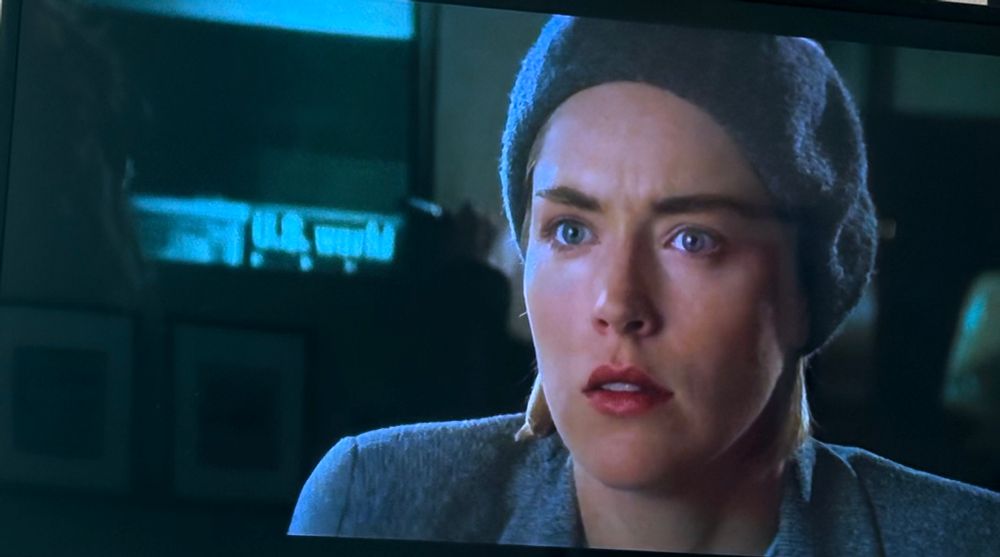 Sharon Stone investigates by using a microfiche in Sliver