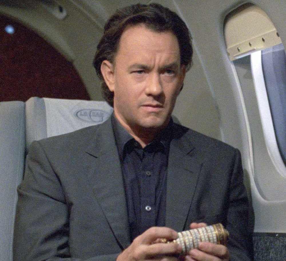 Tom Hanks with the hair of a 90s real estate agent who moonlights as a magician in the Da Vinci Code 