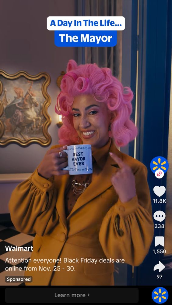 Stephanie Beatriz in a pink wig as a mayor in a Walmart ad
