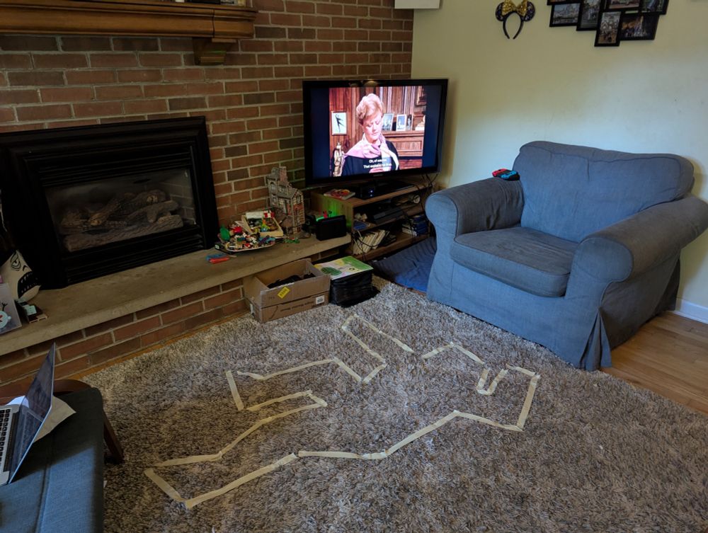My living room carpet with forensic tape in the shape of a 7 year old Caucasian male while Jessica Fletcher looks on 