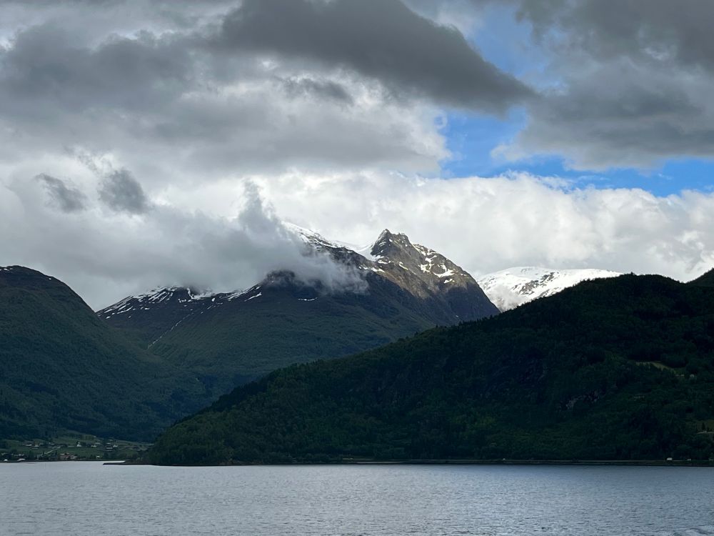 Looking across to the village of Loen in Norway, from a cruise ship sailing away from Olden on the Nordfjorden.