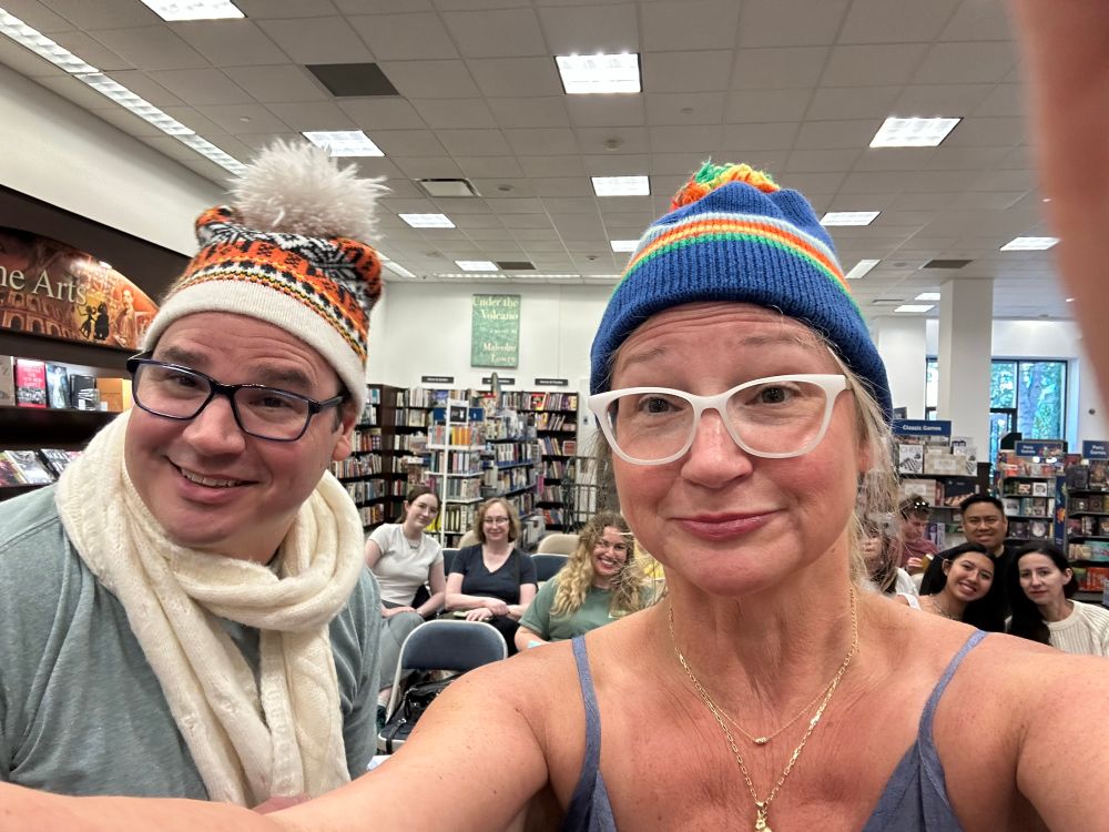 Authors Matthew and Jennifer Holm at their B&N Irvine event wearing authentic 1970s winter hats with large pom poms. 