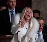 Marjorie Taylor Greene in a white fur coat, being her obnoxious self at Biden’s State of the Union address. Yelling and jabbing her finger to make a more forceful point.