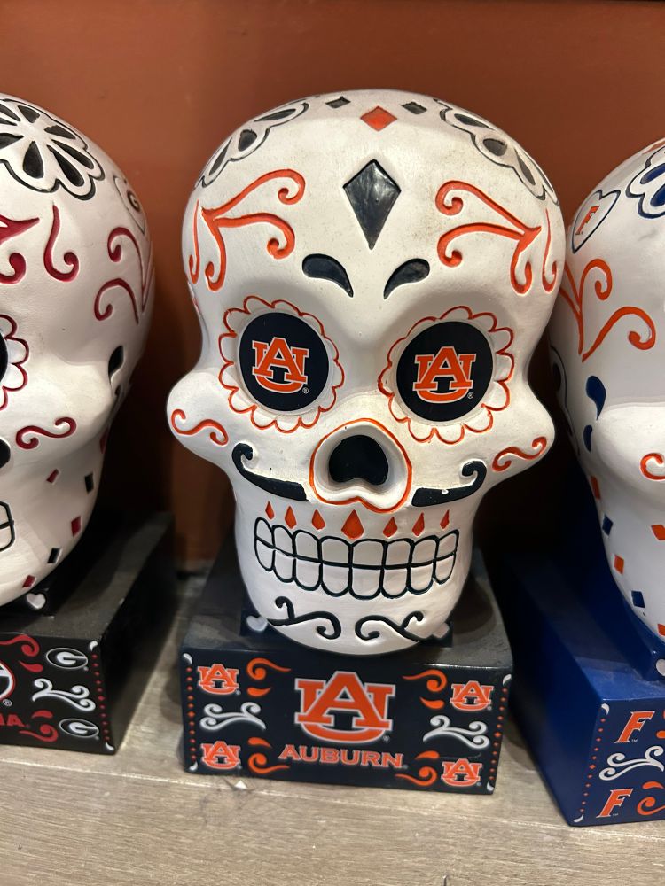 A decorated skull in the style of Mexican sugar skulls, but with the Auburn logo