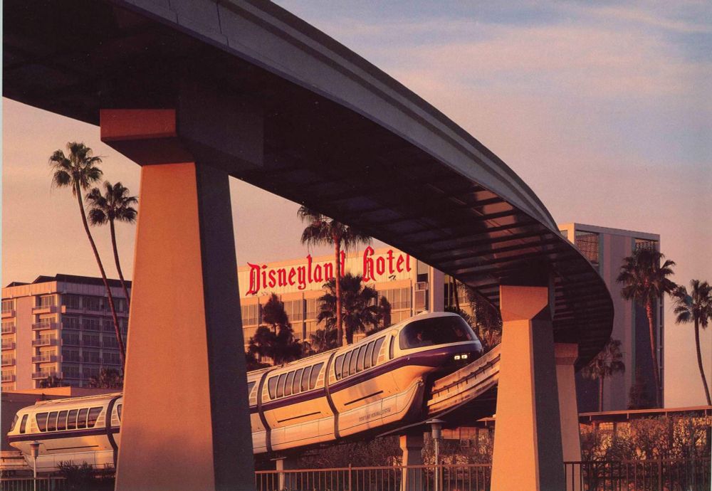 Mark V Monorail Purple passing in front of the Disneyland Hotel at dawn
