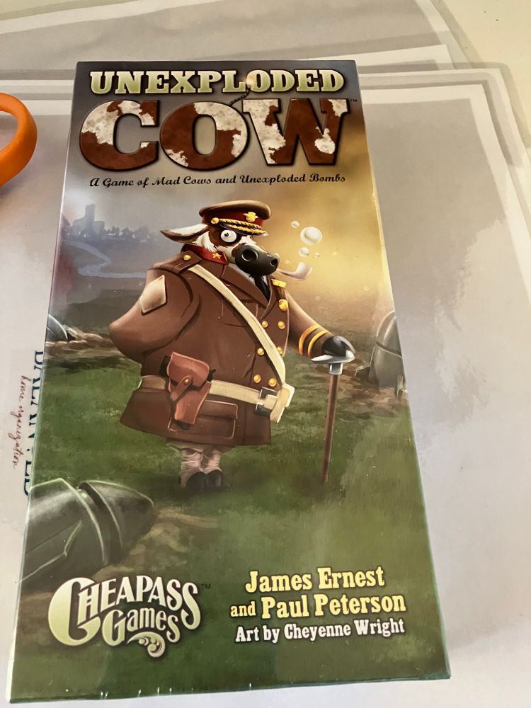 A photo of a card game called “Unexploded Cow,” by James Ernst and Paul Peterson, published by Cheapass Games.