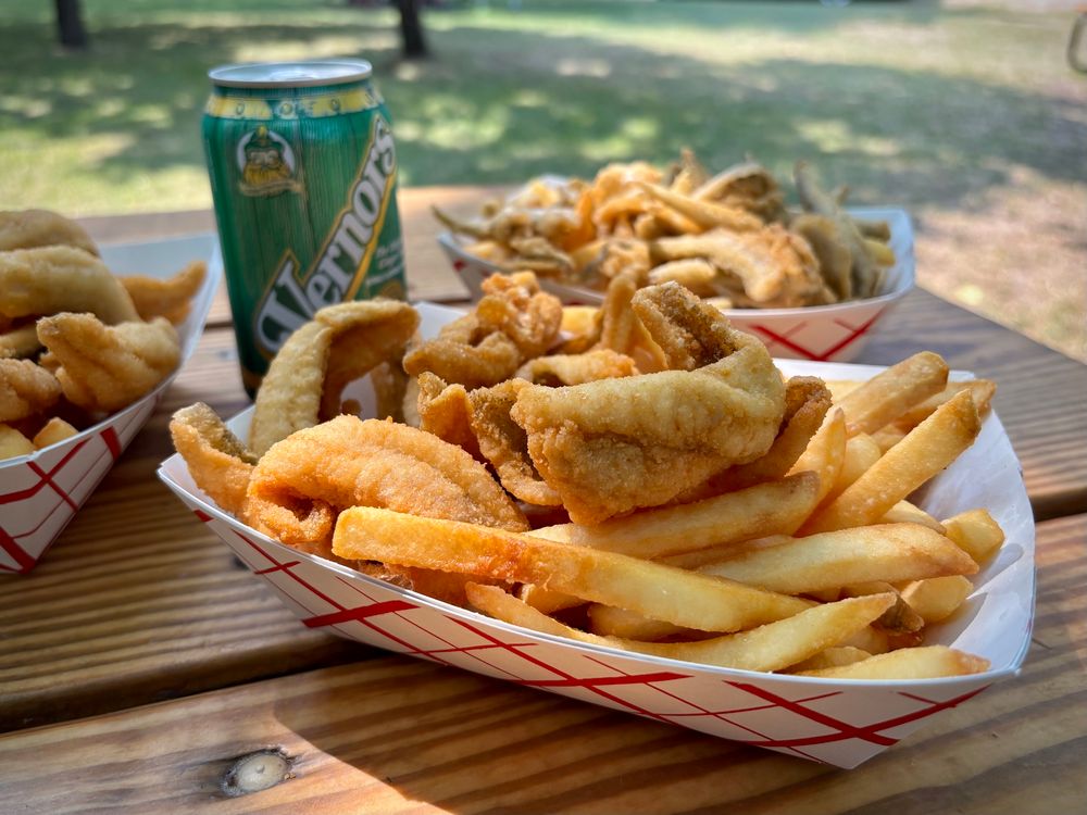 Three baskets of fried fish with French fries, and a can of Vernors ginger ale