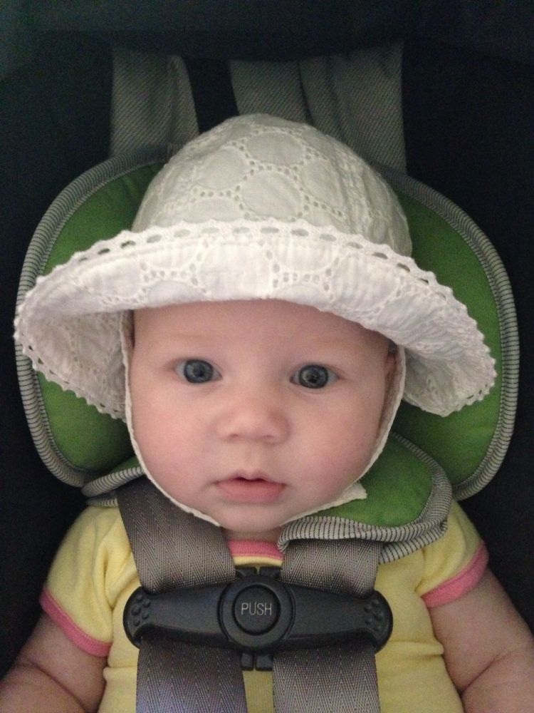 My daughter when she was ~5 months old, in a white eyelet bucket hat