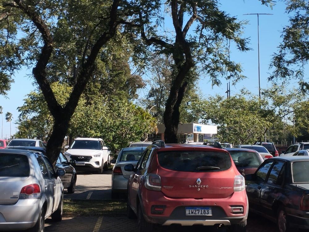 the TDK visitors parking lot, with lots of trees and the reception building in the distance