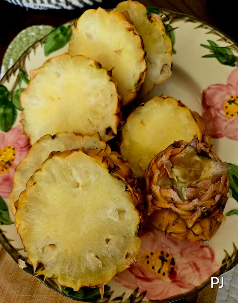 Photo of a Desert Rose Salad Plate with sliced Personal size Pineapple, yellow inside skin on. No core. Health Benefits are awesome.