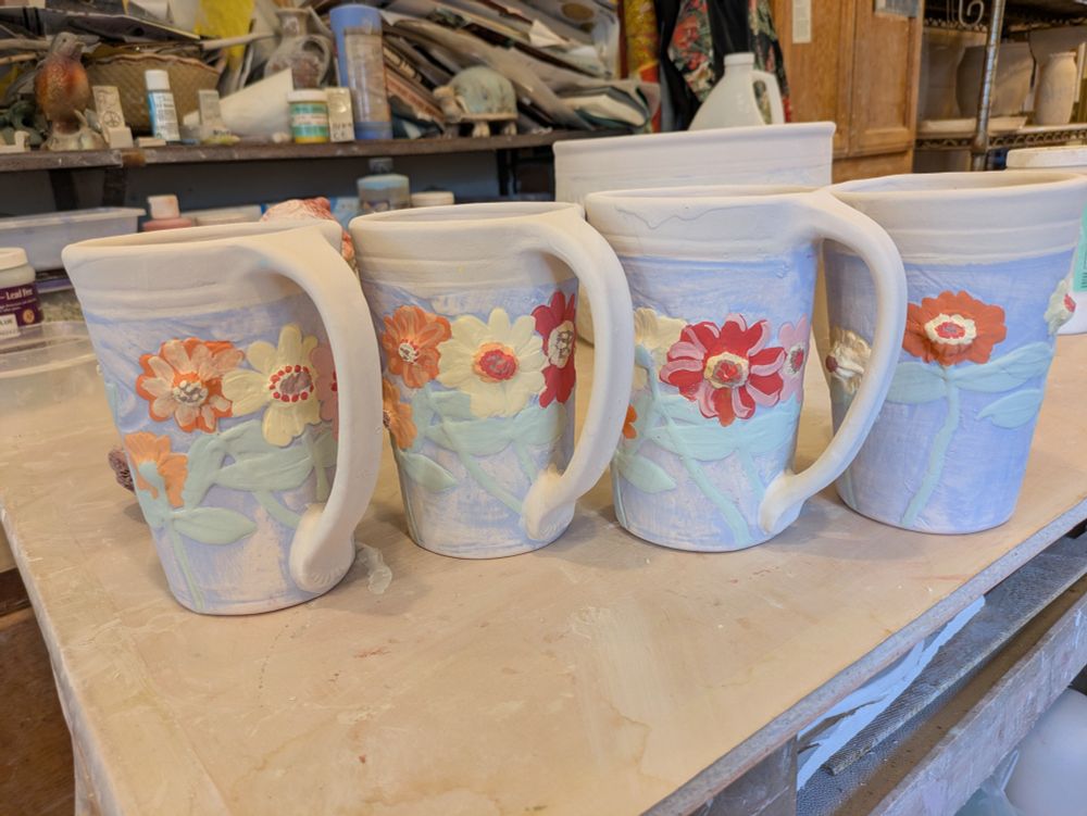 Zinnias on mugs.