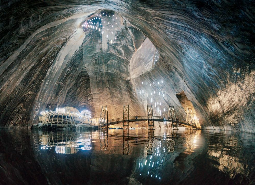 ---+ The Underground Lake That Outshines Dracula's Castle
During a week-long car tour of Transylvania, Romania in May, we visited Salina Turda, the historic Turda Salt Mine that operated from the 13th century until 1932 before reopening as a tourist attraction in 1992. At its deepest level, 26 floors underground, lies a subterranean lake. It was a wonderful experience to row across this dimly lit lake. I captured this image using a fisheye lens and combined two exposures to achieve an even more expansive perspective.
-- ƒ/4.0, 12 mm, 1/30 sec, ISO 6400, Sony A7 II, Rokinon 12mm F2.8, HDR, CC BY-NC-SA 4.0, © 2025 Peter Thoeny, @Quality HDR Photography
