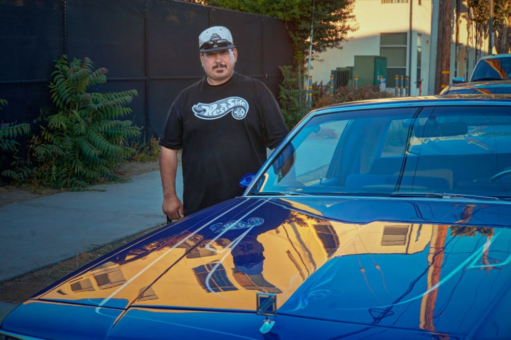 Chicano Pride Meets Chrome and Dreams

I attended an art gathering on Saturday evening at Nicholaus James Dalton's industrial building near downtown San Jose, California, where he provides studio space for artists. Many of the artists belong to the Chicano community. Two lowriders made an appearance at the event. This car culture is deeply rooted in Chicano/Latino communities, particularly in California, and has been an important part of Mexican-American cultural expression since the 1940s-50s. The hydraulic systems allow the cars to bounce and hop. A proud owner poses for me at his vintage Buick Regal lowrider.

-- ƒ/4.0, 50 mm, 1/50, 1/200 sec, ISO 400, Sony A7 II, Canon 50mm f0.95 "Dream Lens", HDR, CC BY-NC-SA 4.0, © 2025 Peter Thoeny, @Quality HDR Photography