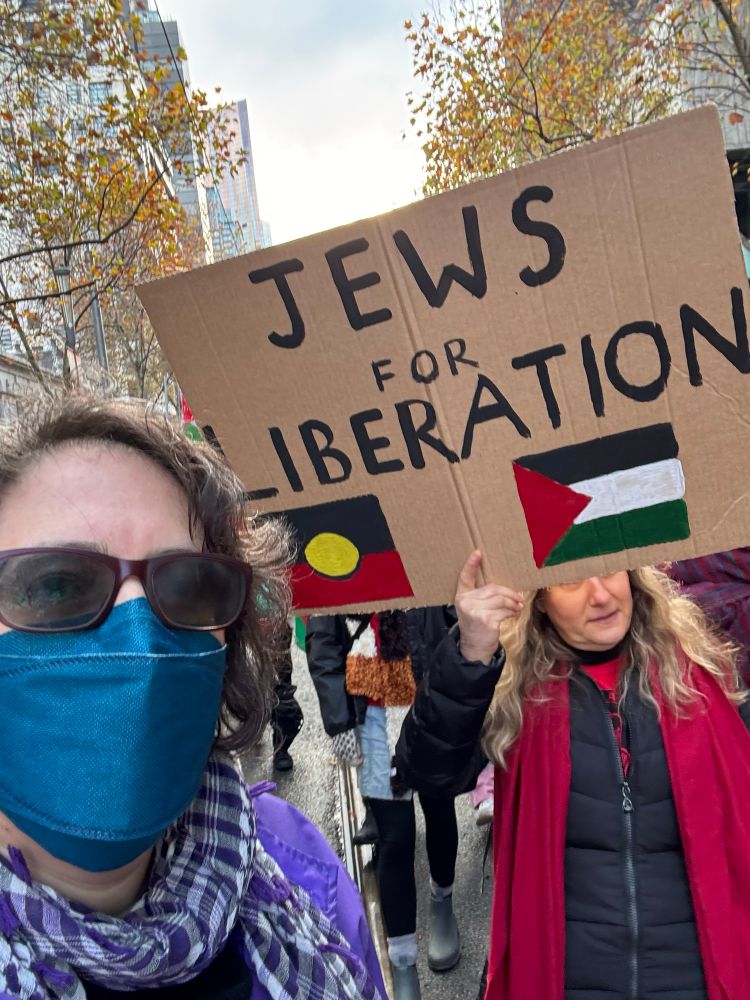 Me and V, and a sign that says Jews for Liberation with the Aboriginal flag and the Palestinian flag. 