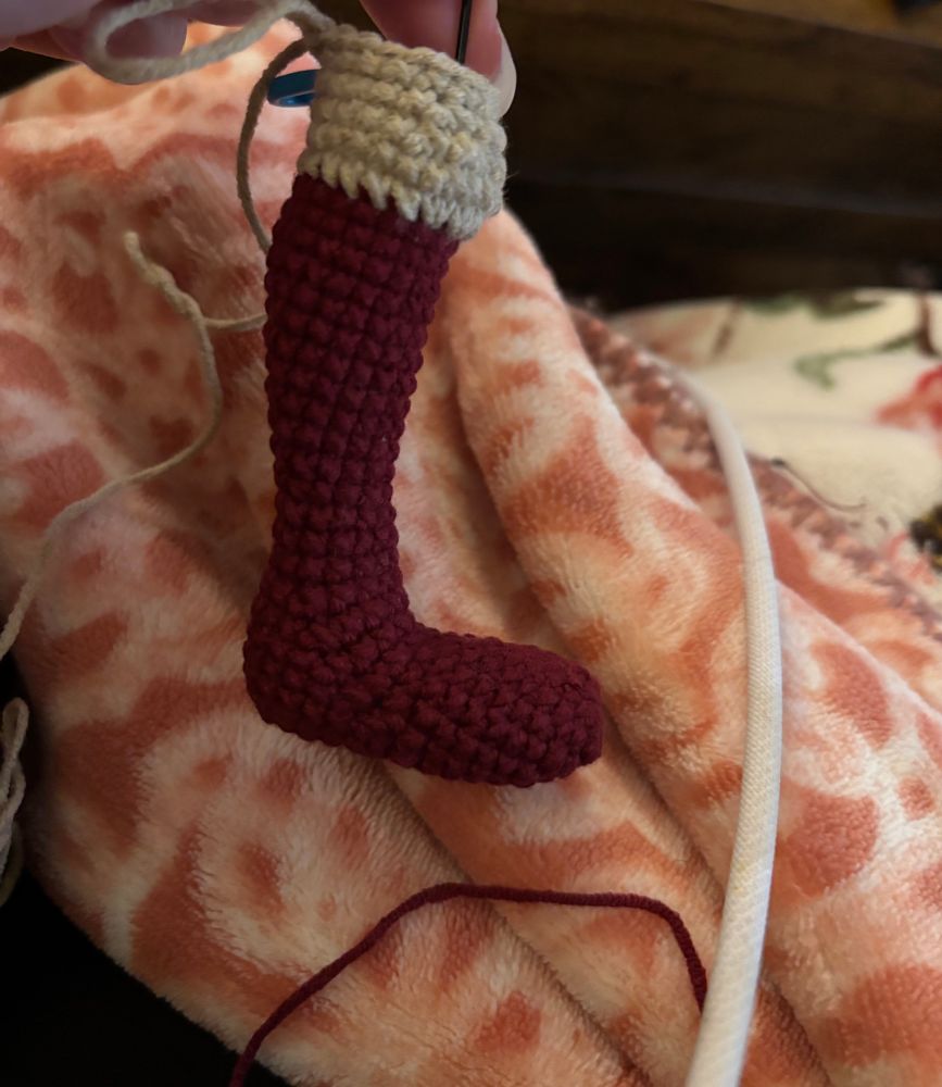 A photo of an amigurumi doll in progress. So far. Just the boot and knee.