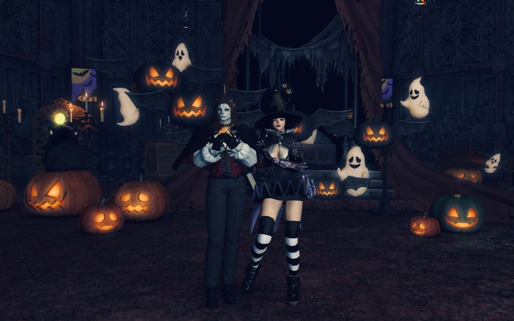 My female Viera in a witch outfit standing next to her Hrothgar Cat Wife who is dressed like Dracula. They are in front of a spooky Halloween backdrop in a Victorian-esque haunted mansion with cute ghosts and jack-o-lanterns.