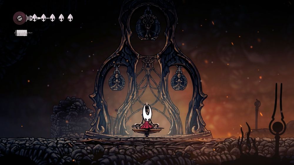 Screenshot from Hollow Knight Silksong depicting hornet sitting on a bench with an eerie surrounding of bells and rocks