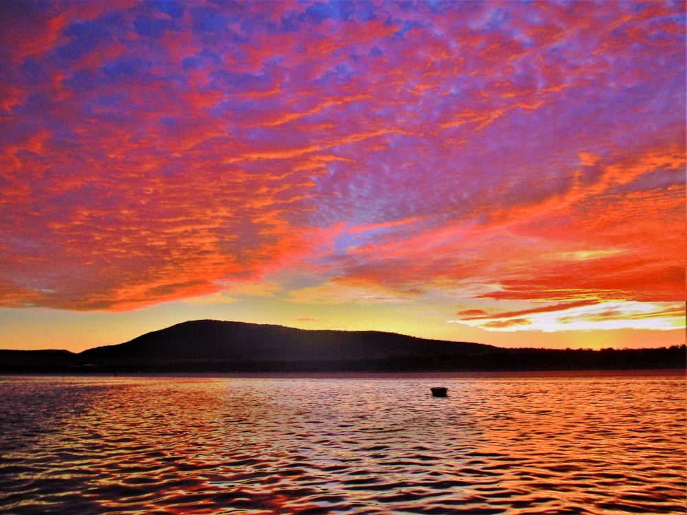 Sunrise over land from a boat in the sea