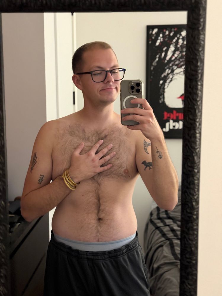 Will, a gay, in gym shorts and layered gold bracelets 