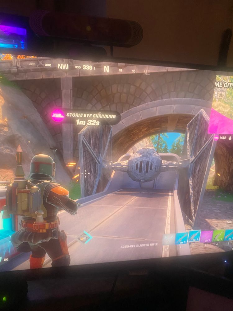 A tie fighter parked awkwardly on a moving train that is just leaving a tunnel. Boba fett looks at his parking proudly. 