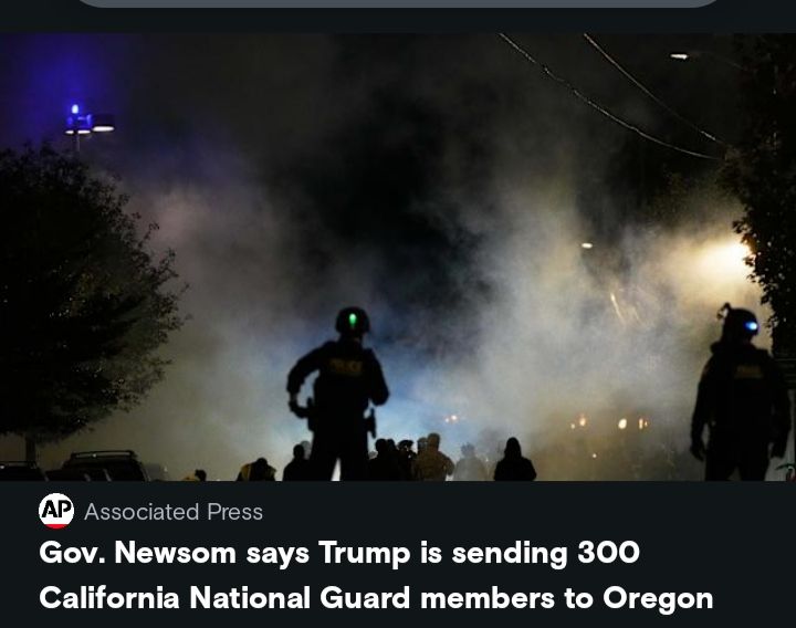 Picucture of what seems to be soldiers at night with smoke in the background. The headline from the Associate Press reads: Gov. Newsom says Trump is sending 300 California National Guard members to Oregon
