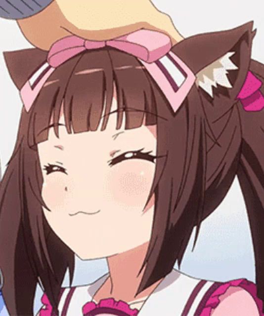 a person is putting a pink bow on the head of a girl with cat ears