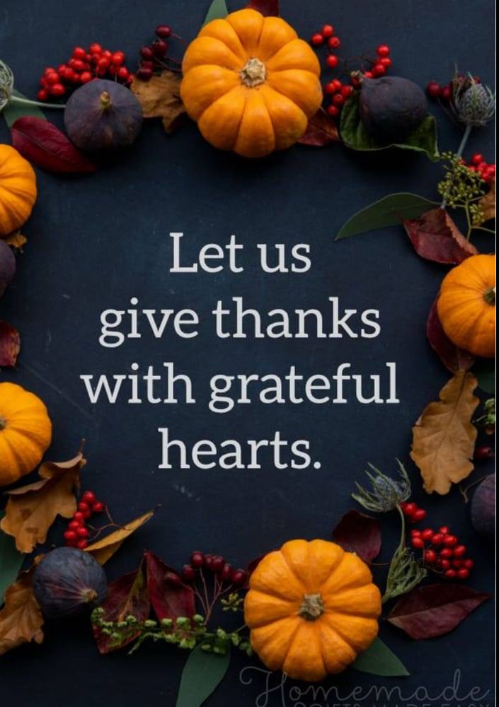 The words “Let us give thanks with grateful hearts” in the center of a wreath of mini pumpkins, leaves, and berries
