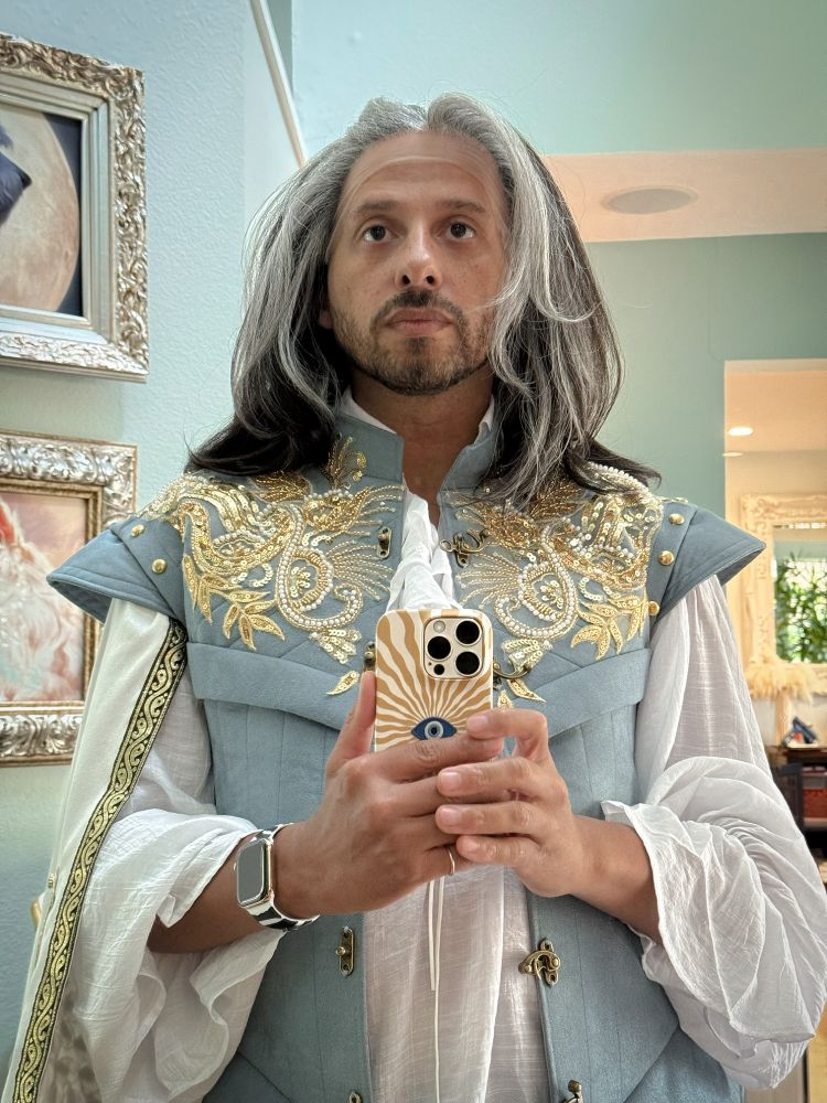 a photo of nephelomancer wearing costume pieces that make them look like a fruity prince