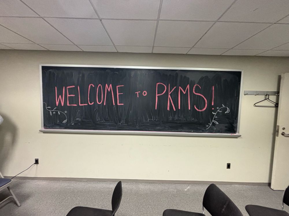 A blackboard on which is written “welcome to pkms”