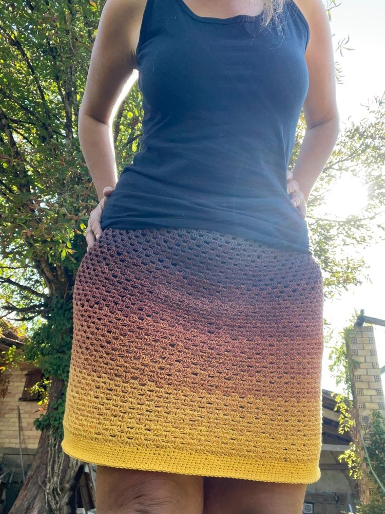 Photos de ma jupe au crochet, avec un point légèrement texturé et avec un léger effet de transparence, qui va du jaune au gris en passant par le marron, en dégradé.